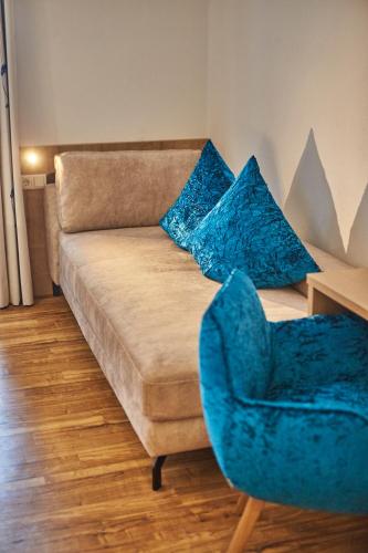a living room with a couch and a chair at Johanneshof - Dein MOUNTAIN Wohlfühlhotel in Saalbach Hinterglemm