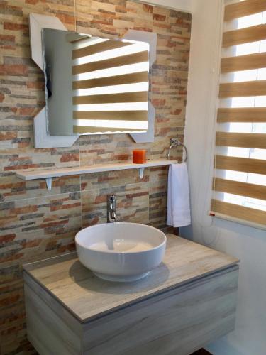 a bathroom with a sink and a mirror at HOTEL COLIBRÍ in Creel