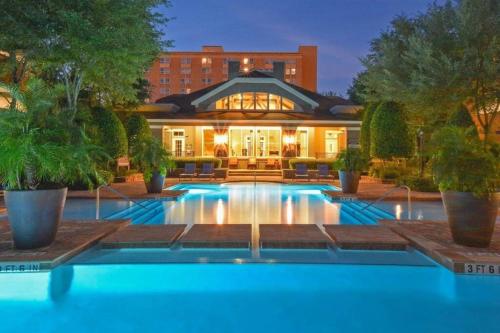 a swimming pool in front of a building at Newly Furnished 1BR Apartment w/ Hermann Park View in Houston
