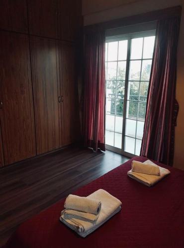 a room with two towels on a bed with a window at Kika Court 2 in Paralimni