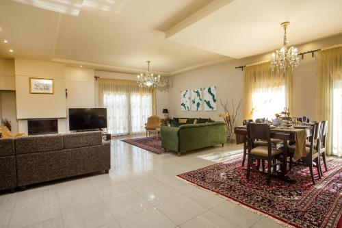 duży salon ze stołem i kanapą w obiekcie Villa de Manu w mieście Rodos