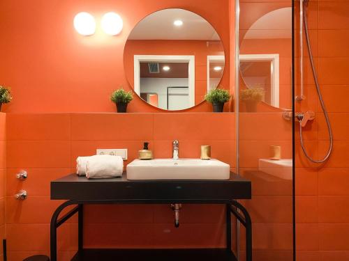 a bathroom with a sink and a mirror at Astoria Apartments in Nuremberg