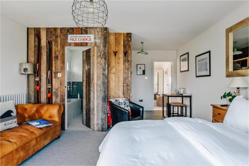 a bedroom with a bed and a couch at The Gate Cornwall in Looe