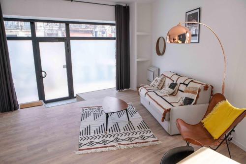 uma sala de estar com uma cama e um sofá em Modern Air Conditioned Apartment em Bordeaux