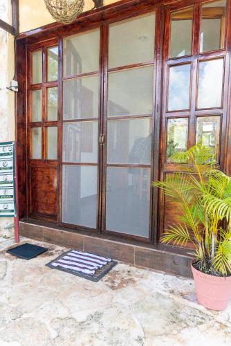 an entry to a house with a large glass door at Aldea Isla Sagrada in Cozumel