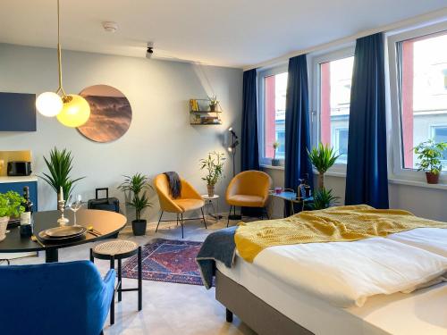 a bedroom with a bed and a table and chairs at Astoria Apartments in Nuremberg