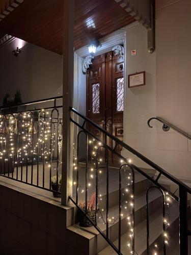 a staircase with christmas lights in front of a door at Hotel i Restauracja Castle in Bystrzyca Kłodzka