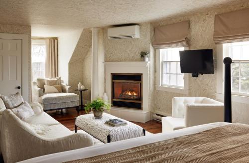 a living room with a couch and a fireplace at Kennebunkport Captains Collection in Kennebunkport