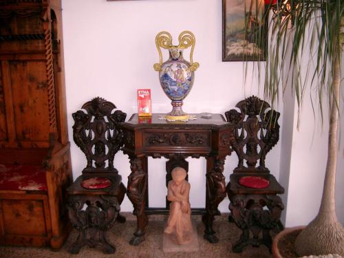an old wooden table with a vase on top of it at Hotel La Riva in Giardini Naxos