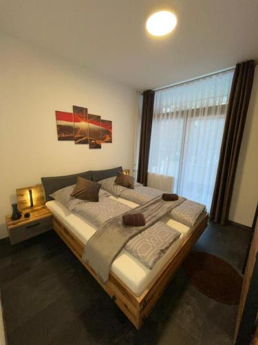 a bedroom with a large bed in front of a window at Mariposa 4 incl Pool & Sauna in Bad Harzburg