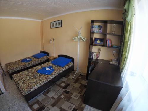 ペトロパブロフスク・カムチャツキーにあるApartment on Tushkanova 17のベッド2台と本棚付きの部屋