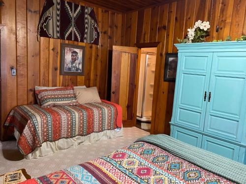 a bedroom with two beds and a blue cabinet at Live Oak B&B in Glen Rose