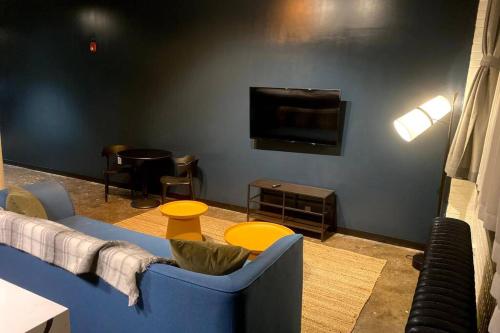 a living room with a couch and a flat screen tv at 3E-*New* 3 min to Hillman Cancer Center, Sleeps 6 in Pittsburgh