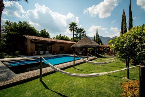 a resort with a hammock by a swimming pool at Quinta Ascensión Hotel Boutique Only Adults in Malinalco