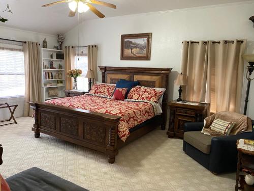 a bedroom with a large bed and a chair at Live Oak B&B in Glen Rose