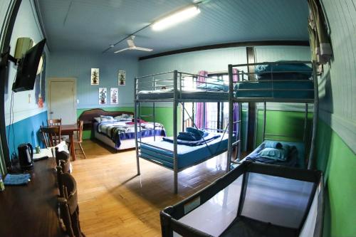 a room with two bunk beds and a table at Batchelor Butterfly Farm in Batchelor