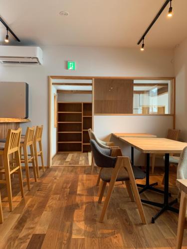 a dining room with a table and chairs at やどバーTATSUJi in Joetsu