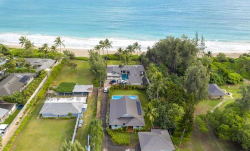 an aerial view of a house on the beach at Gorgeous Renovated 1937 Plantation Style Beach House 50 Steps to the Center of the Beach home in Kailua