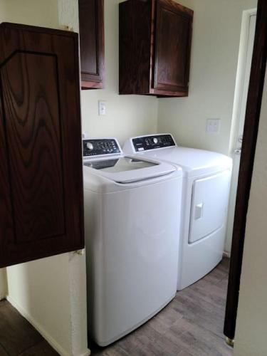 a washer and dryer in a small room at The Villa - Amazingly Comfortable King Beds in Alpine