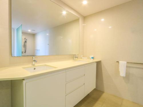 a bathroom with a sink and a mirror at Azura Ocean View Holiday Apartment in Kingscliff