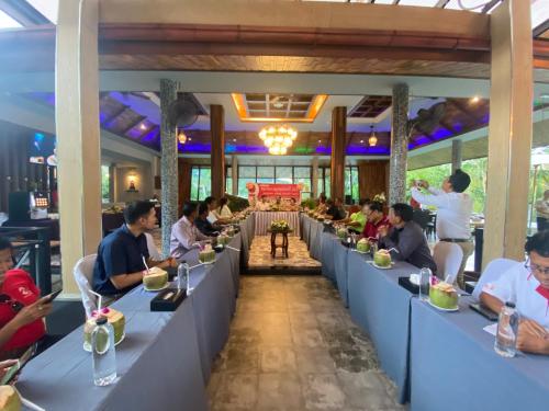 a group of people sitting at tables in a restaurant at The Scene Cliff View Villas in Ao Nang Beach