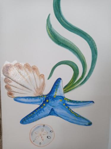 a blue starfish next to a clock and tentacles at Casa Caracola in Tubará