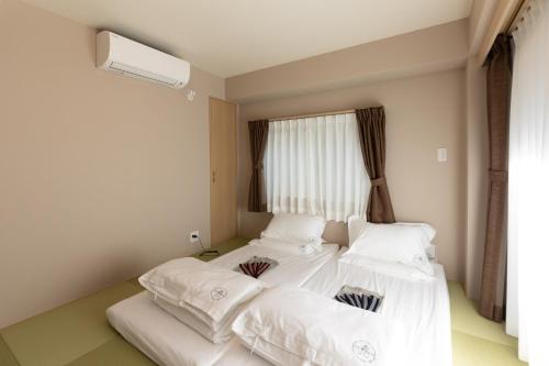 灯光旅館 Light hotelにあるベッド
