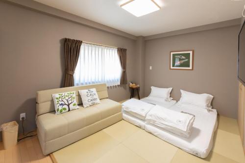 灯光旅館 Light hotelにあるベッド