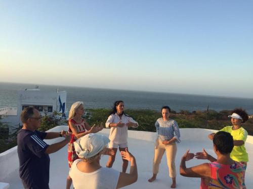 a group of people standing on the edge of a pool at Casa Caracola in Tubará