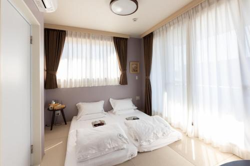 灯光旅館 Light hotelにあるベッド