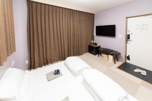 灯光旅館 Light hotelにあるベッド