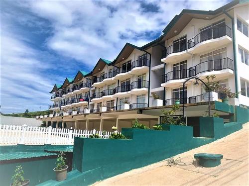 a large building with balconies on the beach at Lake Infinity Luxury Condos in Nuwara Eliya