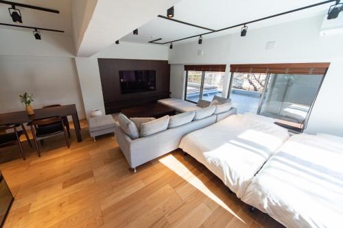 a bedroom with a bed and a couch and a table at NIYS apartments 07 type in Tokyo