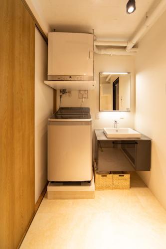 a small kitchen with a sink and a refrigerator at NIYS apartments 07 type in Tokyo