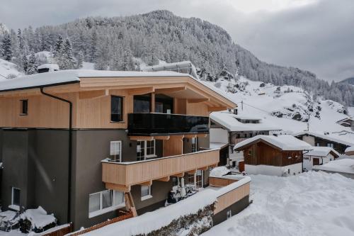 a building in the snow with a mountain at House 55 in Sölden