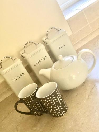 a tea pot and tea cups sitting on the floor at Wisteria Cottages are self catering cottages in a beautiful village location in Dorrington