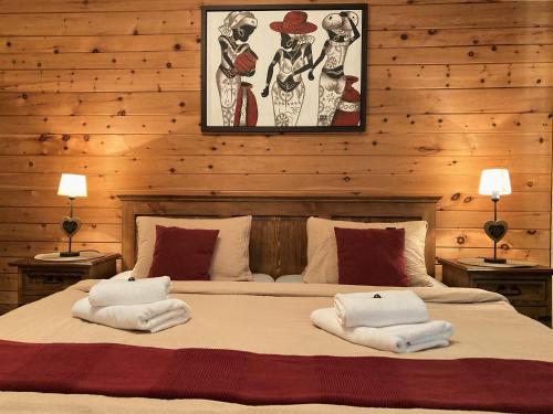 a bedroom with a large bed with towels on it at Haus Treffer in Kirchdorf in Tirol