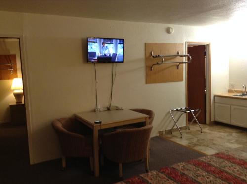 a room with a table and a television on the wall at Front Street Inn in Crescent City