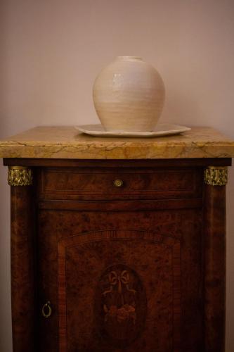 a bowl sitting on top of a wooden table at Palazzino Birgu Host Family Bed and Breakfast in Vittoriosa