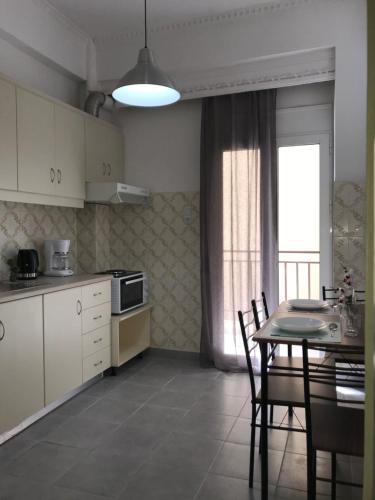 a kitchen with a table and chairs and a dining room at Midway Point Apts in Heraklio Town