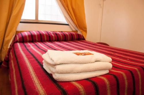 a pile of towels sitting on top of a bed at Wine Aparts in Mendoza