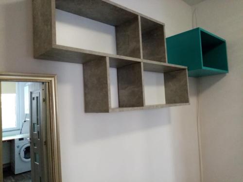 a wall mounted shelf in a bathroom with a mirror at Mountain Loft in Piatra Neamţ