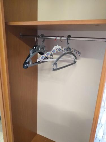 a shelf in a cupboard with two drawers at Joli studio in Saint-Raphaël