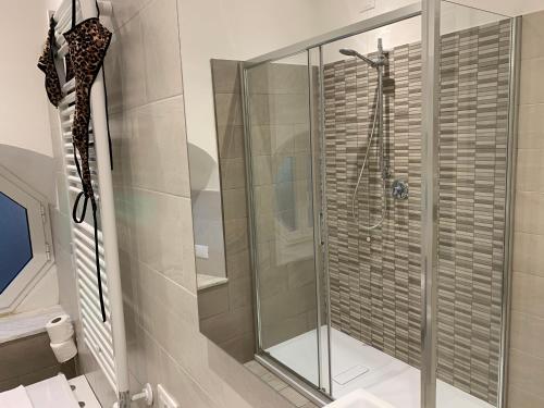 a shower with a glass door in a bathroom at Affittacamere Sapore di Mare in Levanto