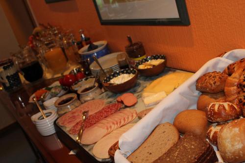 a table full of different types of bread and pastries at Hotel Wintersmühle in Bielefeld