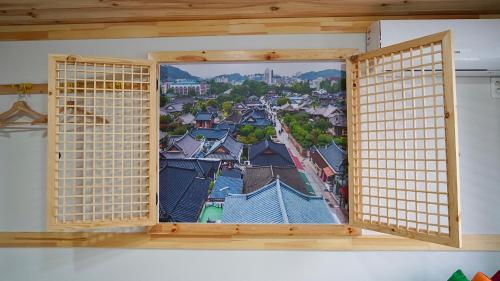 an open window with a view of a city at The Jeongga in Jeonju