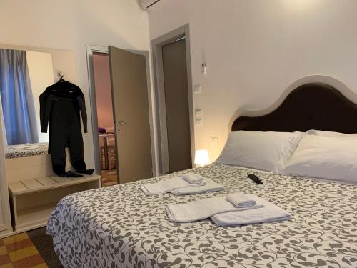 a bedroom with a bed with two towels on it at Affittacamere LevantoMare in Levanto
