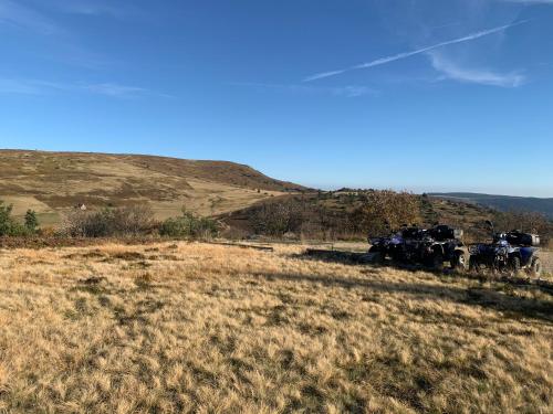 a group of vehicles parked on the side of a hill at Gîte " Orée des bois" in Vertolaye