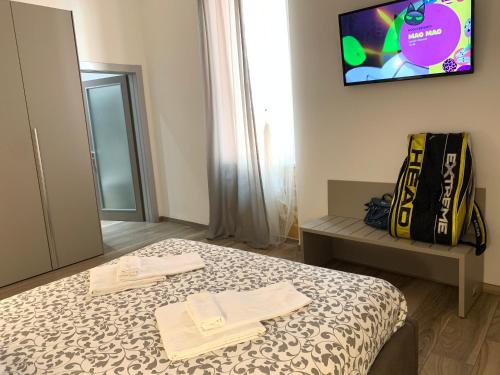 a bedroom with a bed with two towels on it at Affittacamere Il Borgo in Levanto