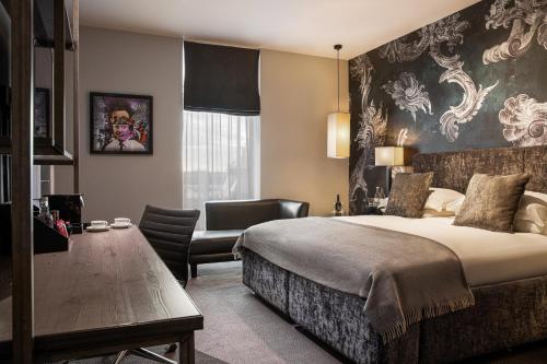 a hotel room with a bed and a chair at Malmaison Liverpool in Liverpool